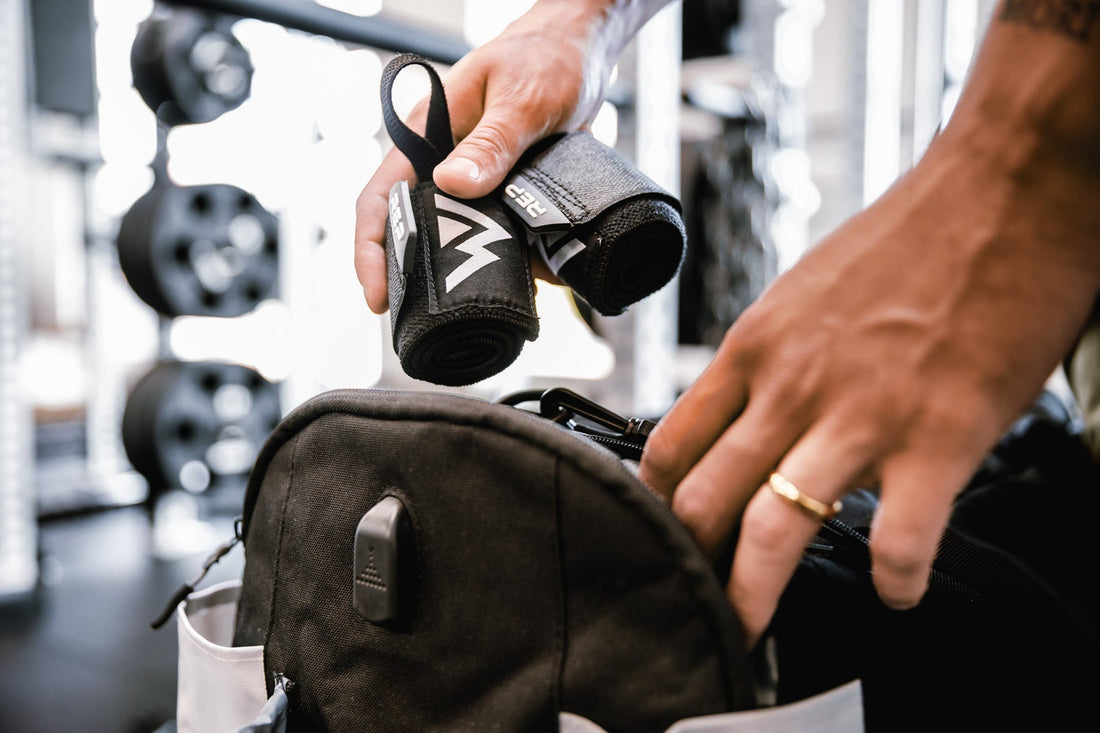 Wrist wraps are placed into a gym bag.