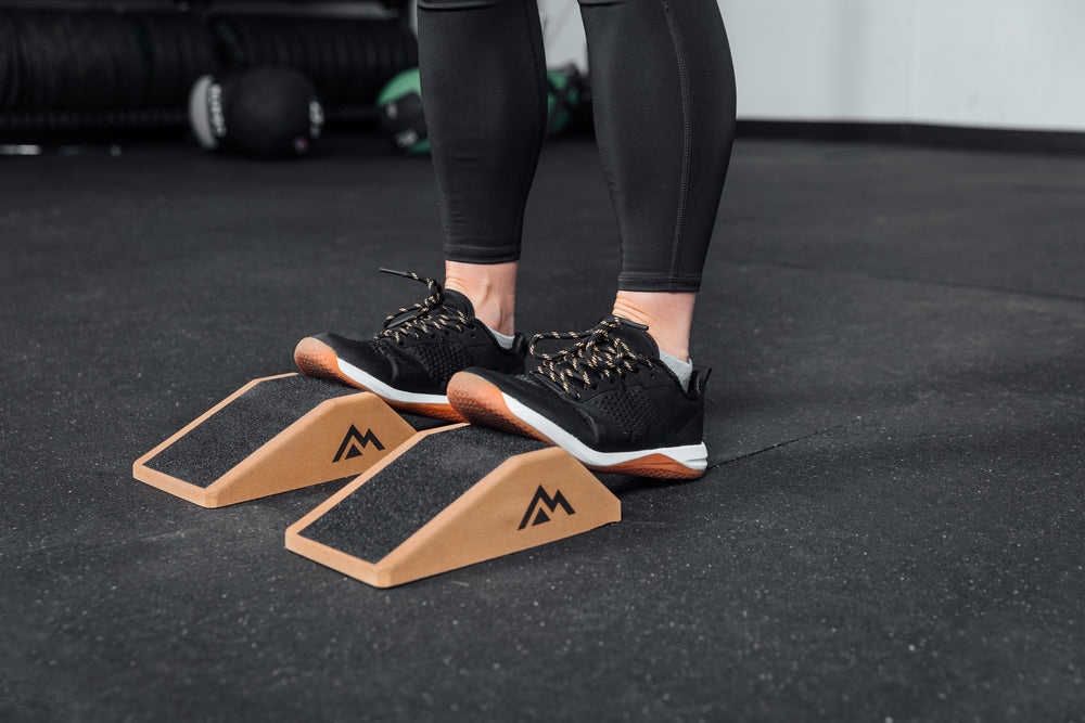 Athlete stretching their calves using Cork Squat Wedges