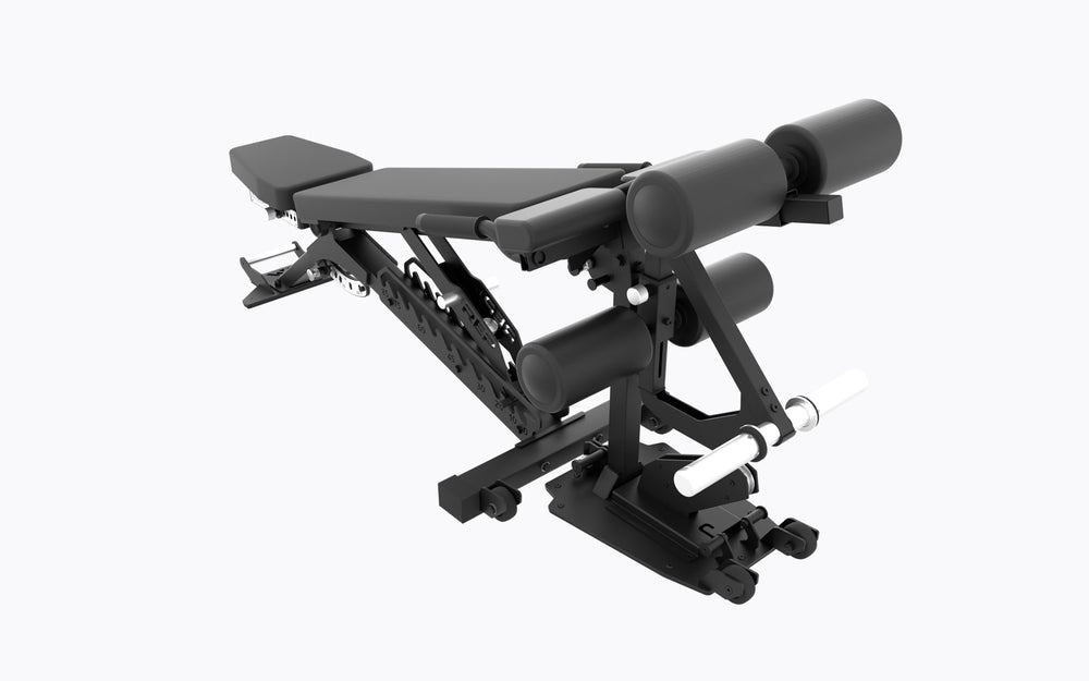 A 3/4 view of the REP Leg Curl/Leg Extension Bench Attachment attached to an adjustable weight bench. This angle highlights the Dual-sided weight horns, Integrated band pegs, Adjustable pads, and Mobility Wheels.