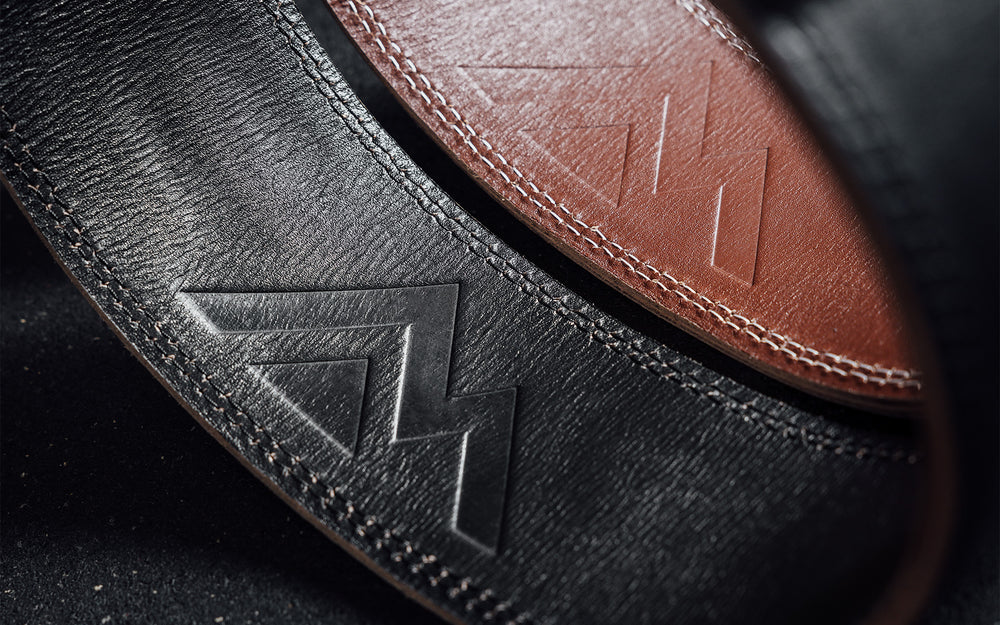 Close-up view of the debossed REP Mountain logo on the back inside part of the brown and black REP Leather Olympic Lifting Belts.