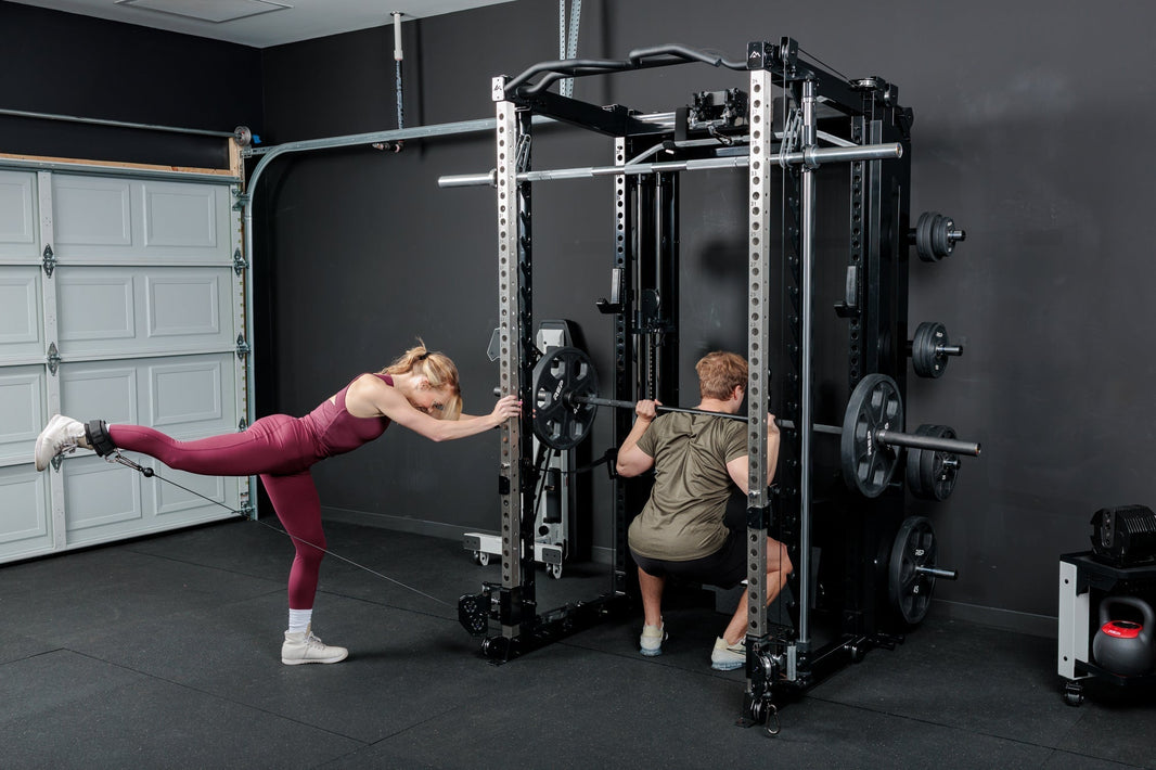 Two athletes work out with the Altitude™ rack.