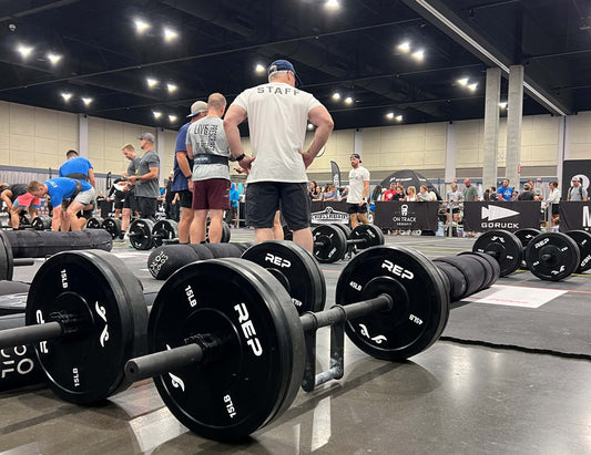 Staff and competitors prepare equipment for a farmer's carry event at the 2025 1st Phorm Monster Games