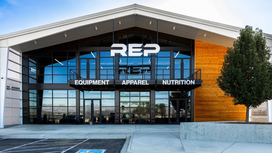 The exterior entrance of REP Fitness's Colorado showroom, with a large REP logo above glass doors and signage reading "Equipment," "Apparel," and "Nutrition."