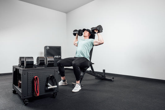 Athlete tackles Arnold press.