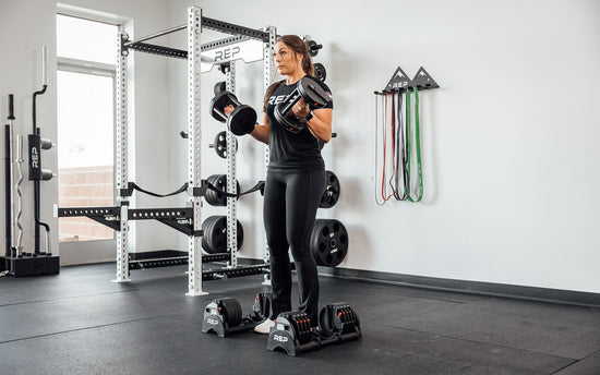 Woman lifting with adjustable dumbbells