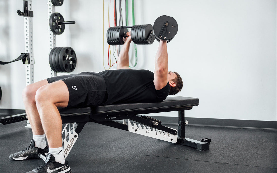 Man working out with adjustable dumbbells