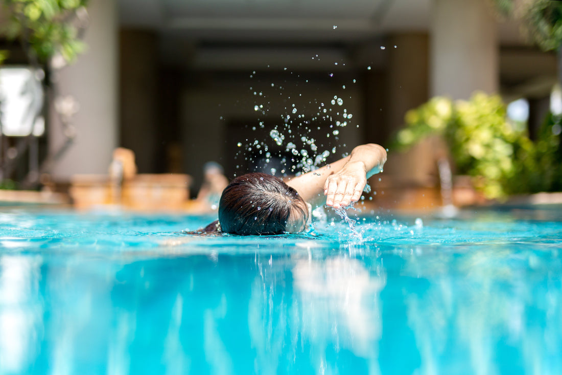 A person swims in a pool.