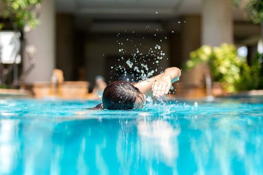 A person swims in a pool.