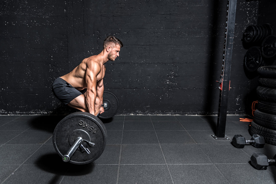 Man performing a barbell romanian deadlift