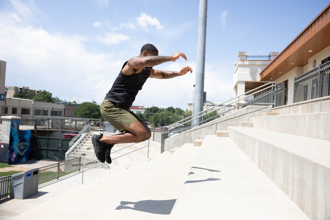 Athlete jumps up stairs.