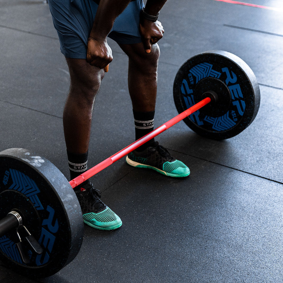 An athlete takes a breath before attempting a hack squat with REP equipment.