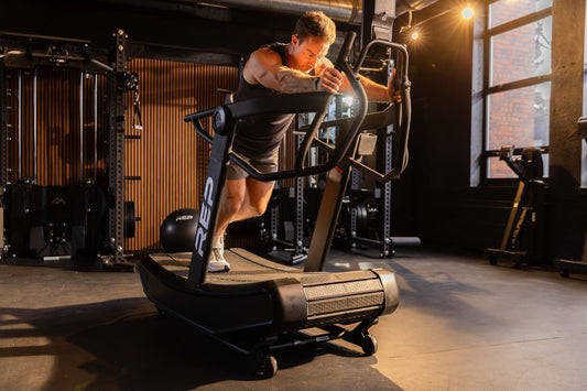 Athlete doing sled pushes on the Strive™ Curved Treadmill