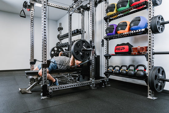 Man benching inside rack with storage