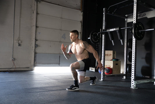 An athlete tackles lunges in their garage gym.
