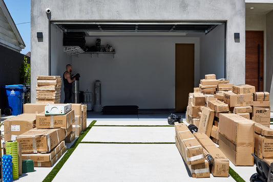 Gym equipment boxes in front of a garage