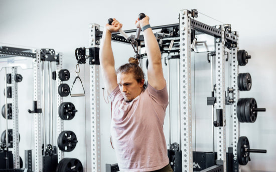 man doing tricep overhead extensions