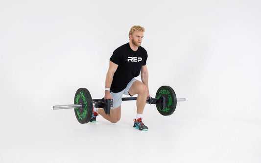 Man performs split squat with open trap bar