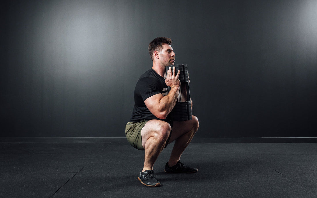 Man doing workout with adjustable dumbbells