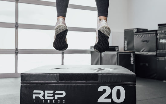 Woman doing box jumps on a soft plyo box