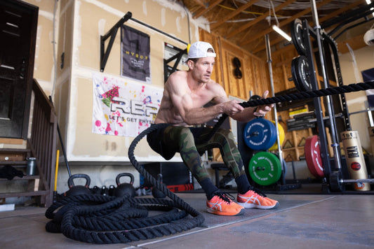 Ryan Kent performs a sled pull while training in his home gym.
