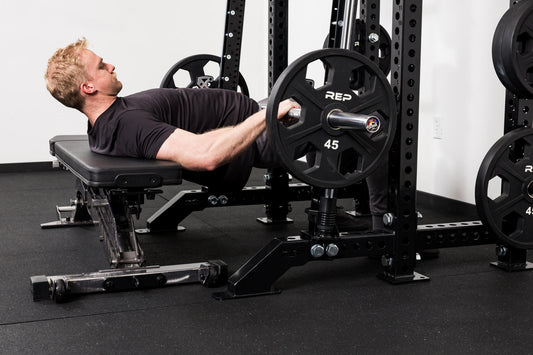 A man tackles hip thrusts with the REP® Smith Machine attachment.