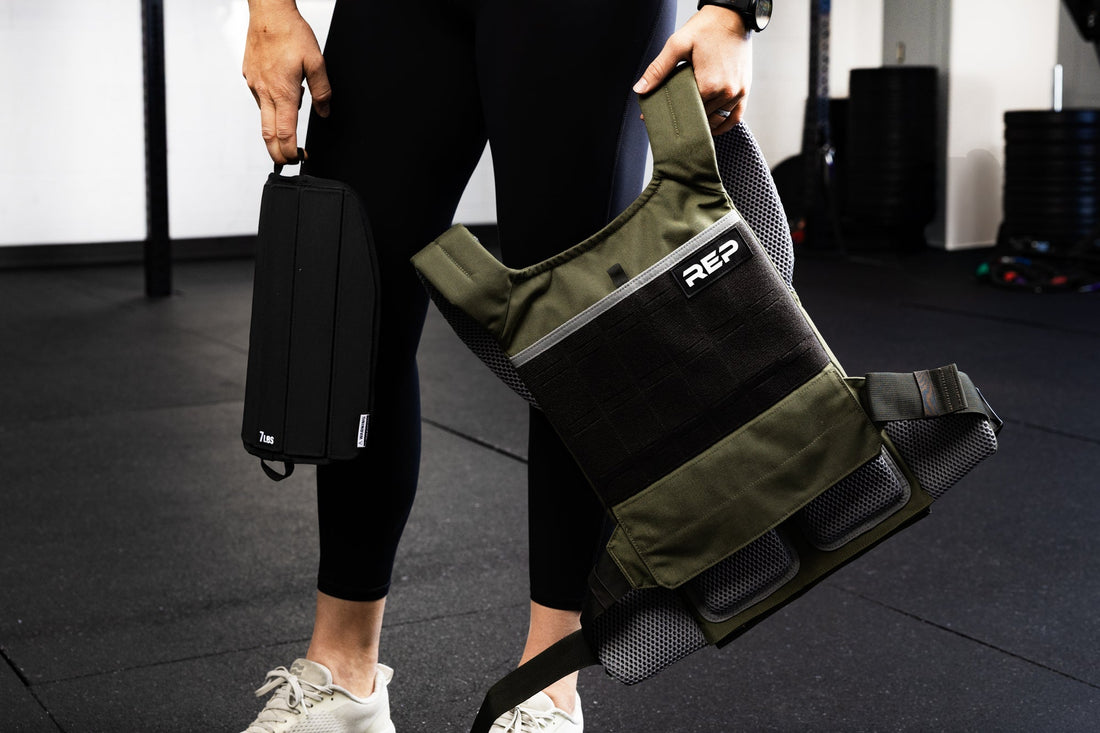 Athlete holds the Strata™ Weight Vest in their hand.