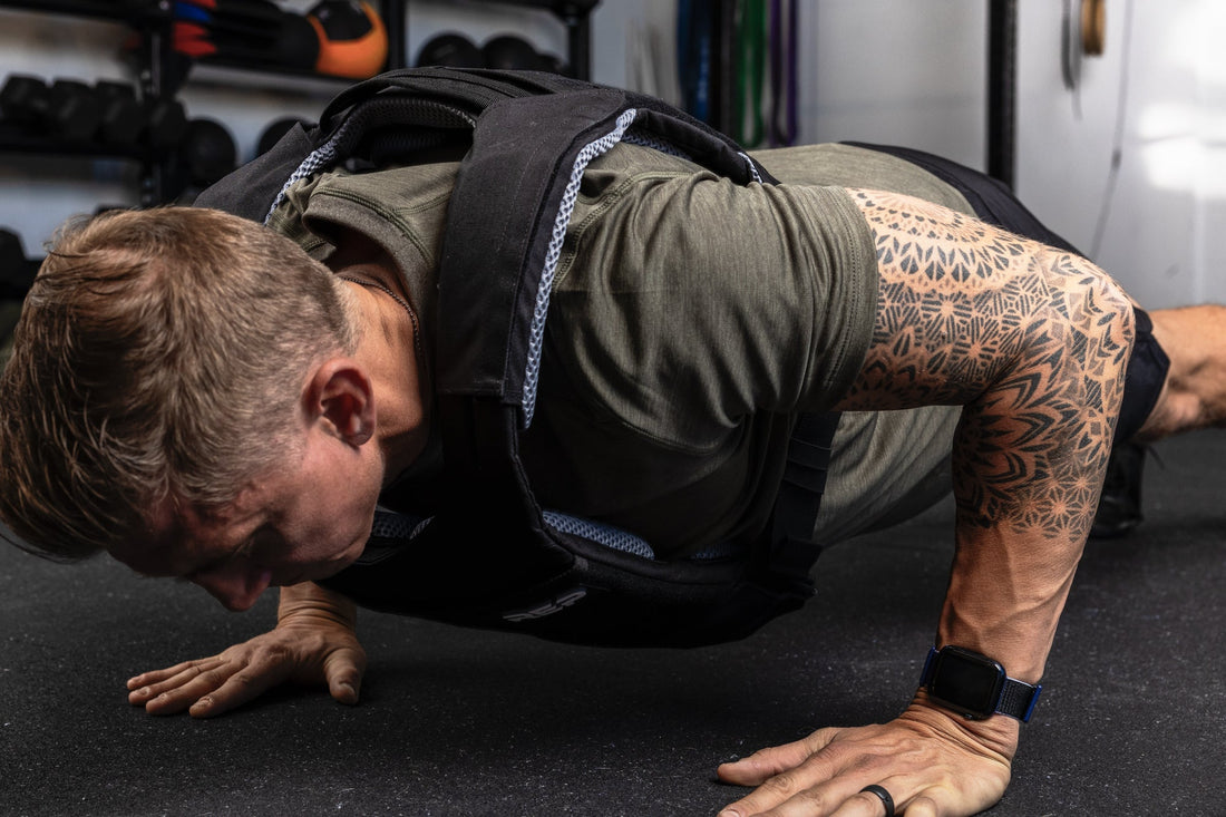 Athlete does push-ups with a weight vest.