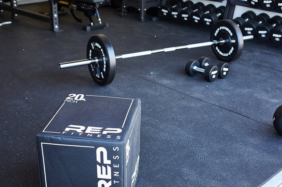 A barbell and plyo box in a gym