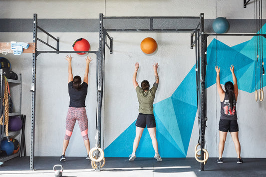 Lifters doing wall ball exercises