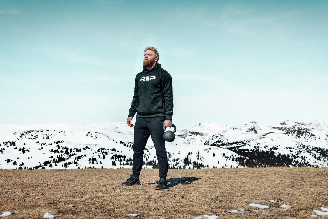 Lifter with a kettlebell on top of a mountain