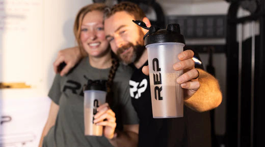 Couple holding shaker bottles