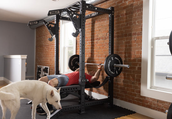 Man benching in a power rack