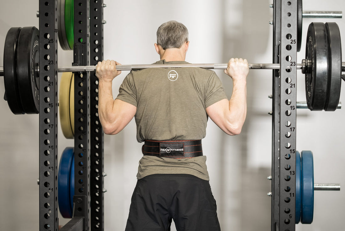 Man squatting with a barbell