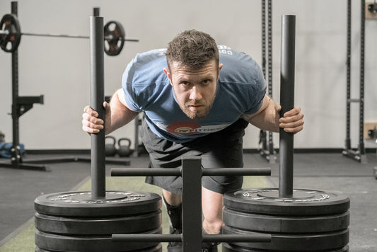 Man doing sled pushes