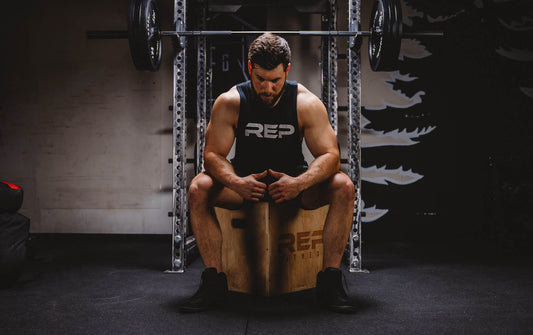 Man sitting on a plyo box