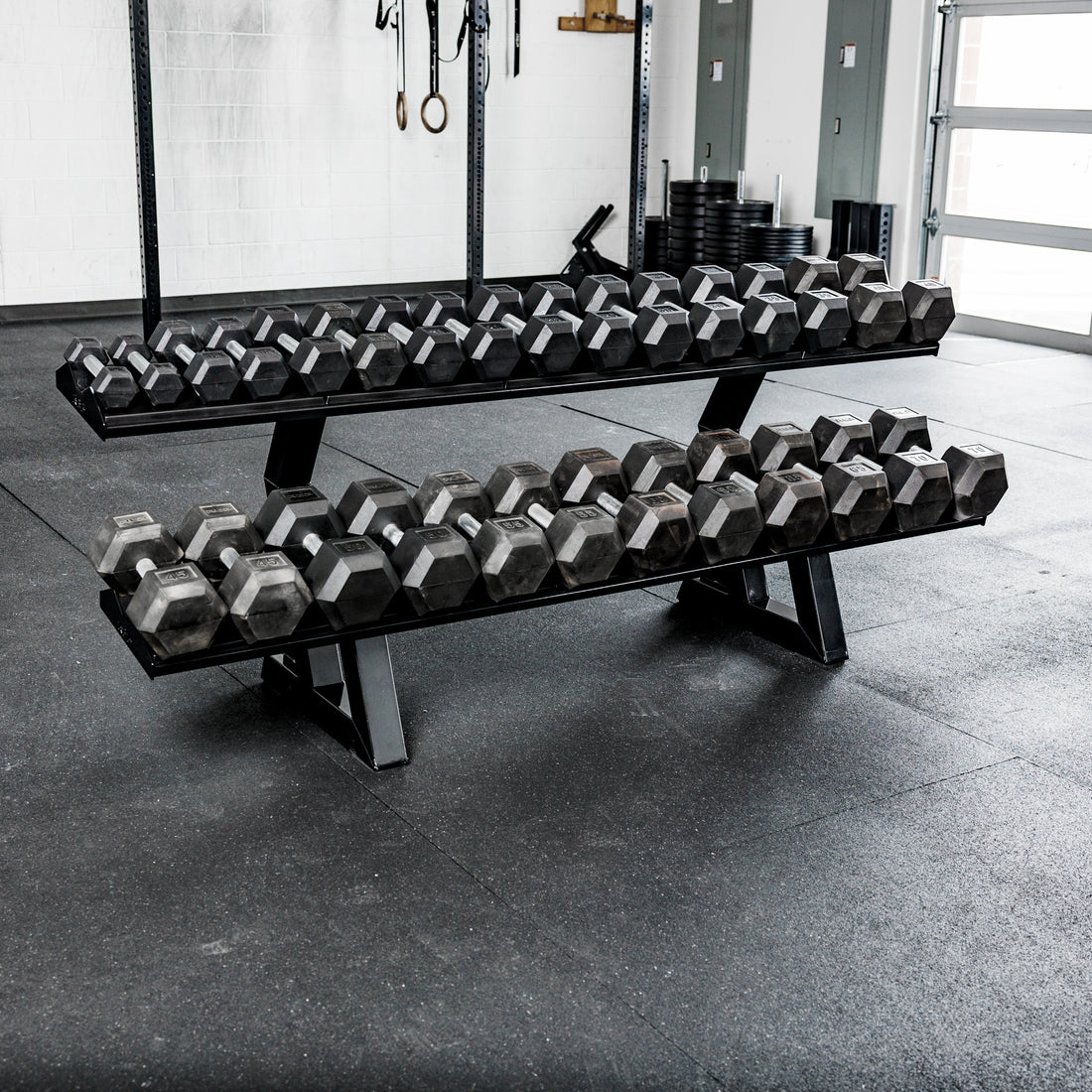 REP Fitness 2-Tier Commercial Dumbbell Rack loaded with Hex dumbbells