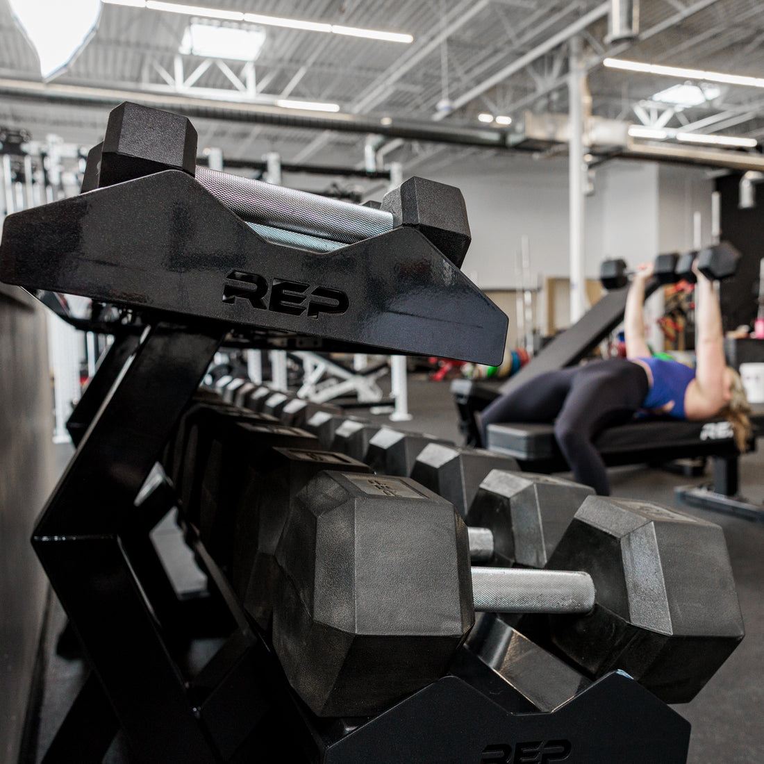 Side view of the REP Fitness Commercial Dumbbell Rack loaded with Hex dumbbells