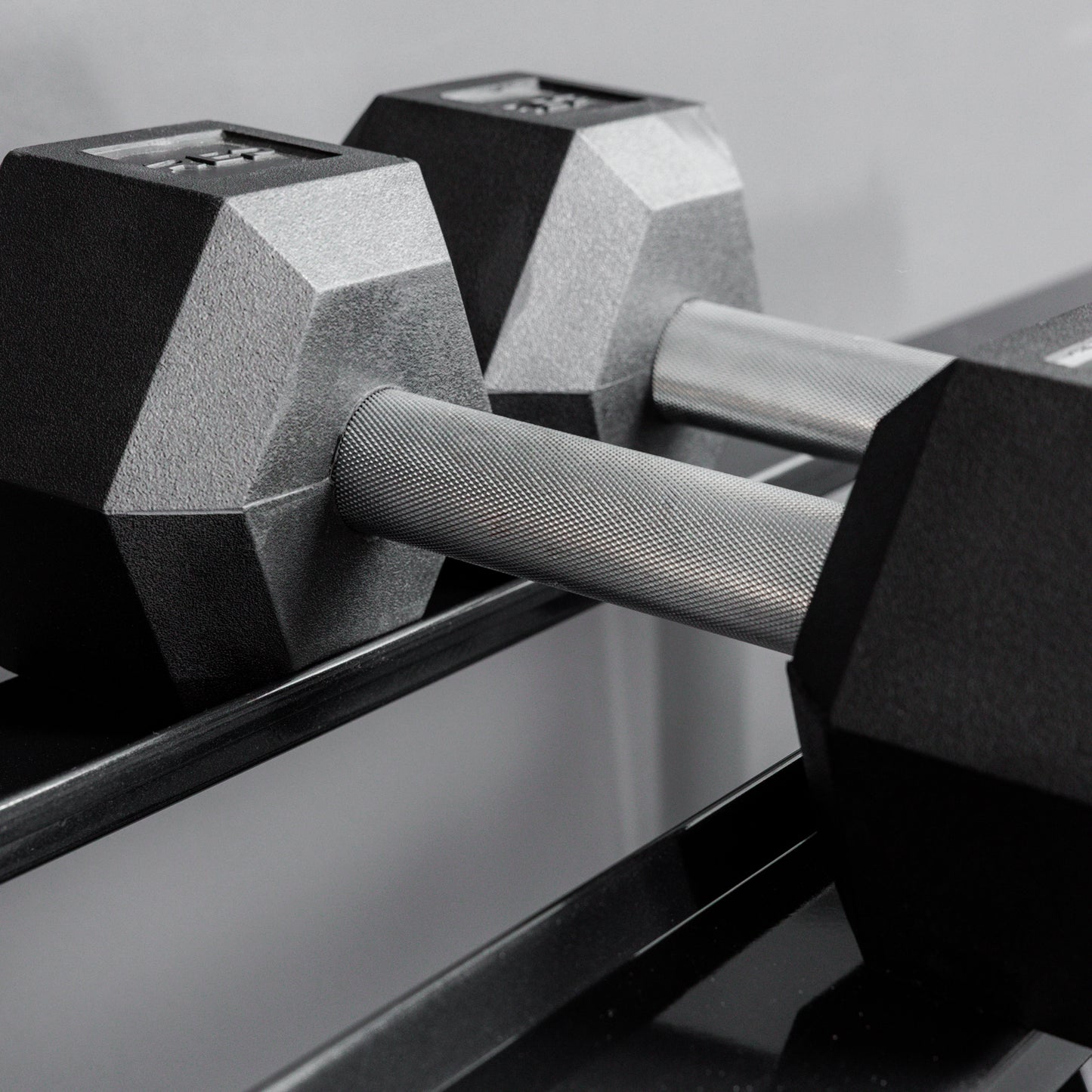 Close-up shot of hex dumbbells racked on the REP Fitness Dumbbell Rack 2.0