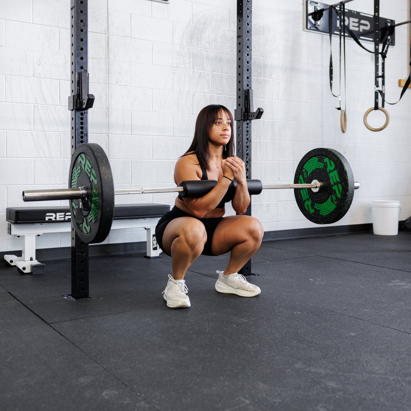 Athlete using the REP Fitness Hip Thrust pad for squats