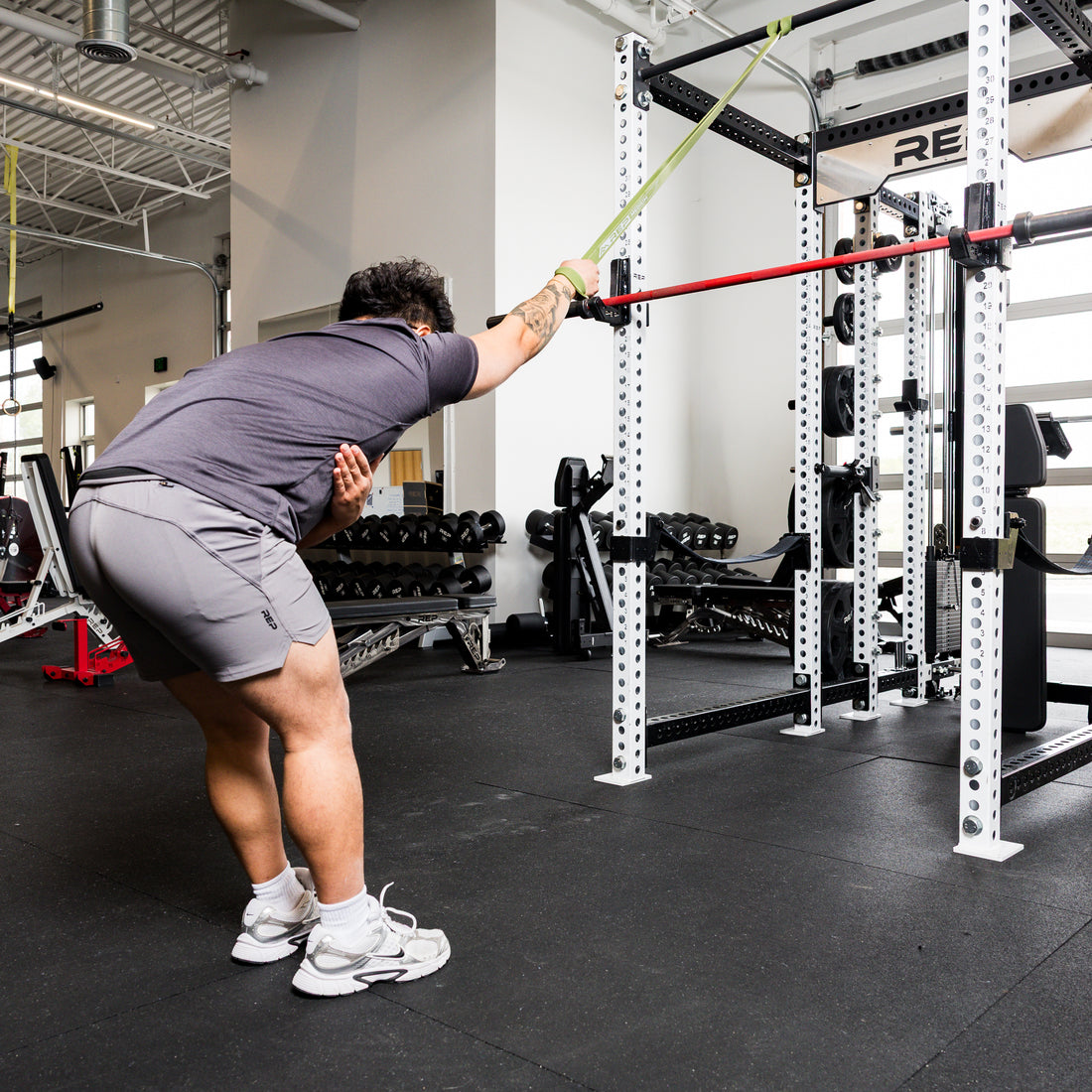 Athlete using the REP Fitness Resistance Bands 2.0 in standing band pulldown