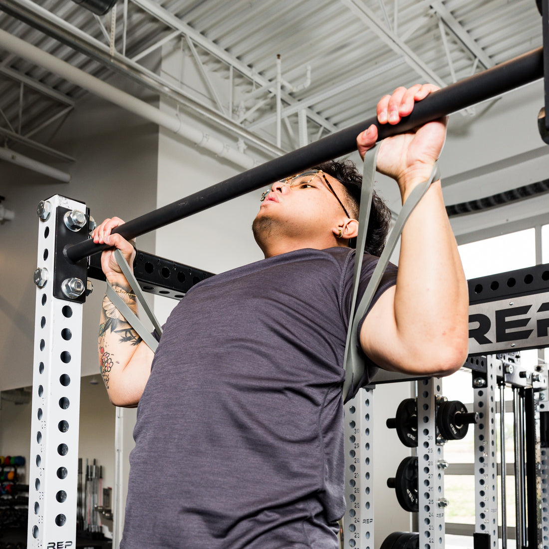 Athlete using the REP Fitness Resistance Bands 2.0 in assisted pull-up