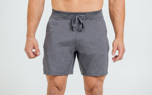 Front view of model wearing the heather cool gray REP Attis Shorts.