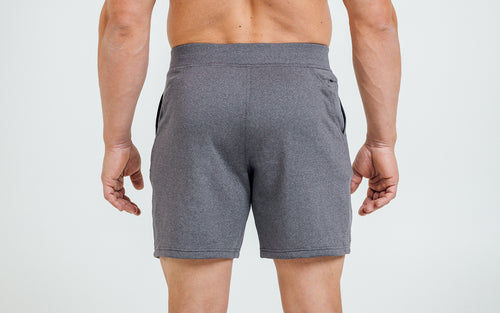 Back view of model wearing the heather cool gray REP Attis Shorts.