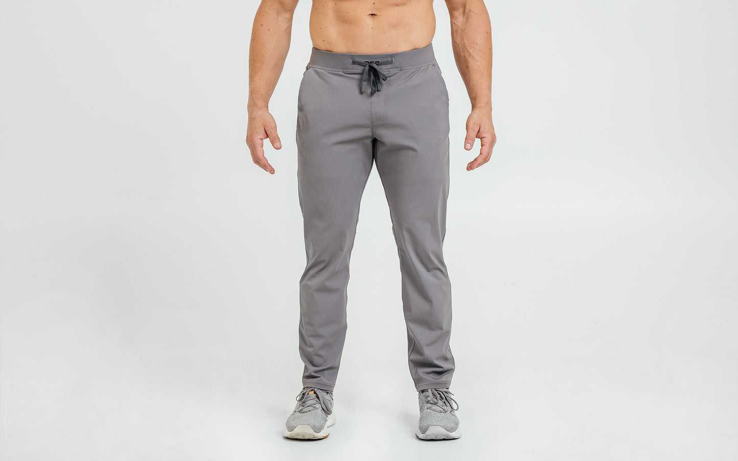 Front view of model wearing the cool gray REP Felix Pants