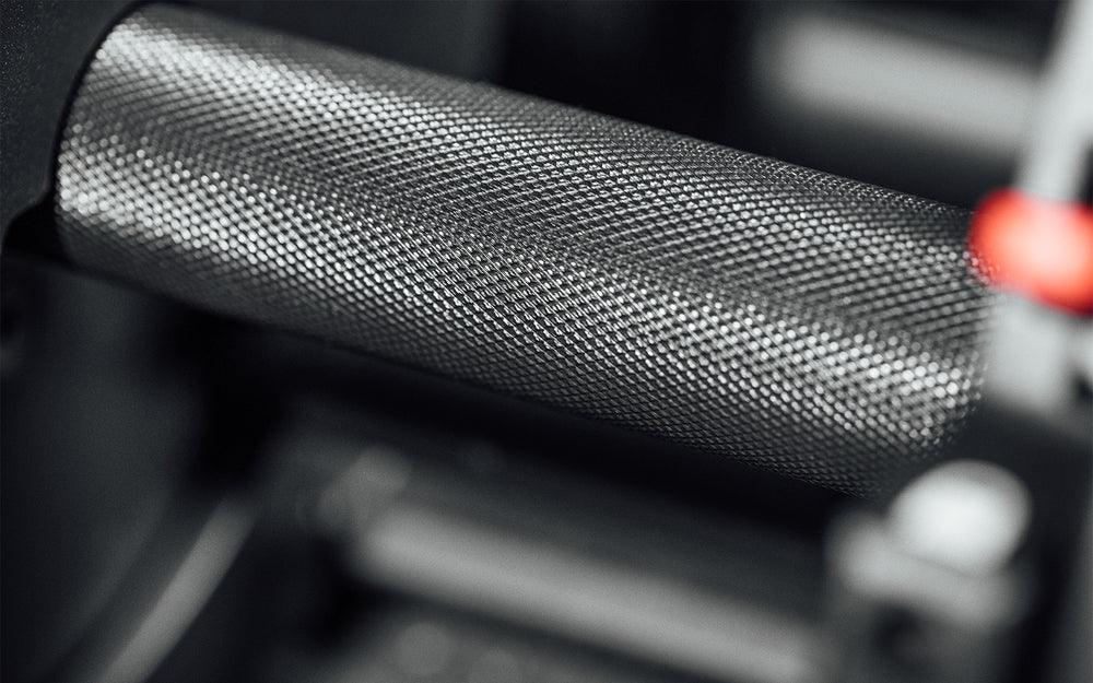 Close-up view of the fully knurled handle of the REP Fitness QuickDraw Adjustable Dumbbell (KG).