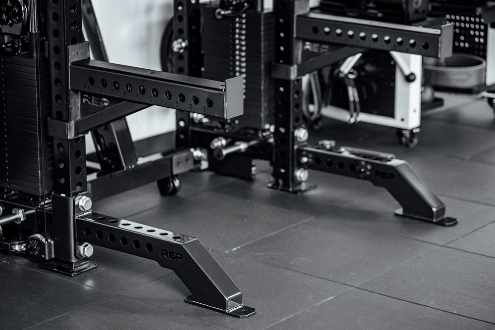 Close-up of a weightlifting rack in a gym setting with Front Foot Extension Pair 2.0

