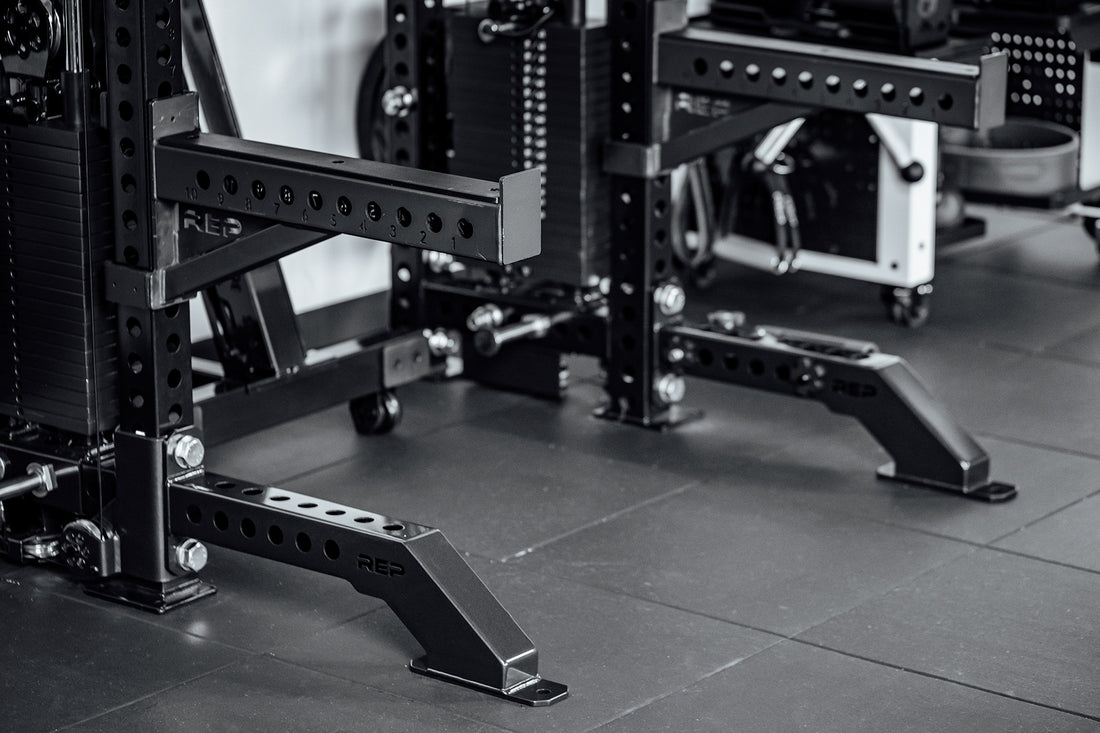 Close-up of a weightlifting rack in a gym setting with Front Foot Extension Pair 2.0

