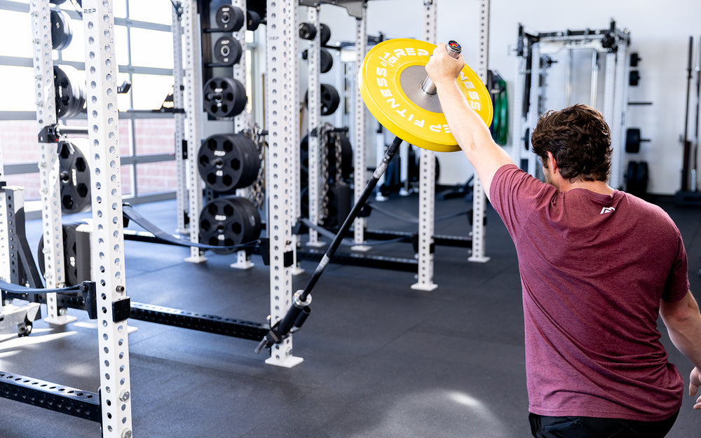 Person using the Colorado Short Bar inside the landmine attachment on a rack