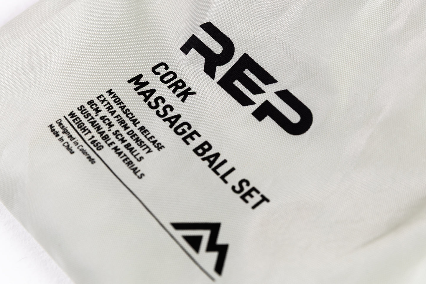Close-Up: REP Cork Massage Ball Set product details printed on the drawstring carrying bag.