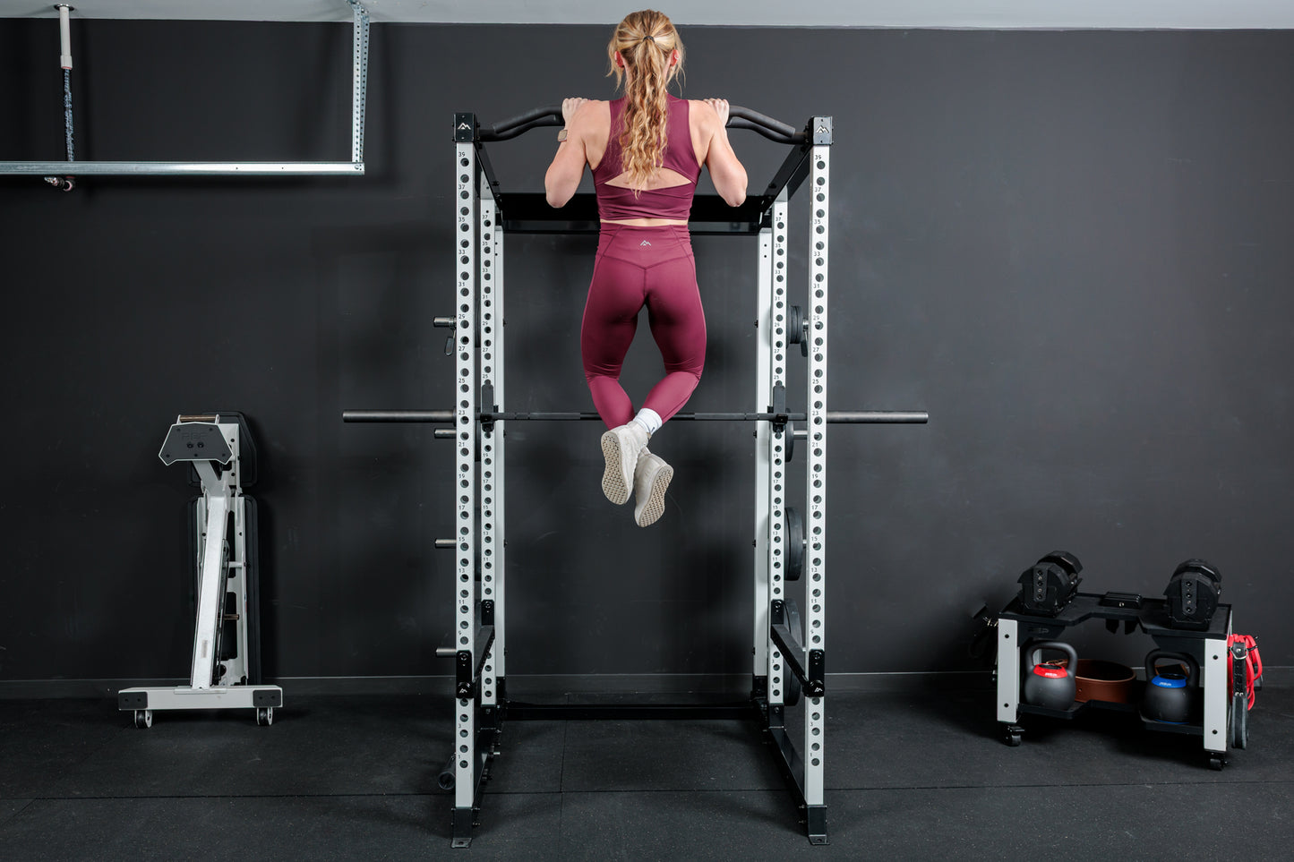 Athlete doing pull-ups on the multi-grip pull-up bar on the REP Fitness Altitude™ Power Rack